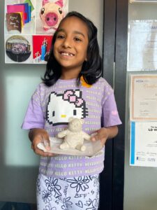 A girl has made panda using paper clay.