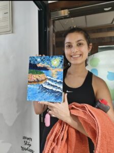 A Girl is showing her painting.